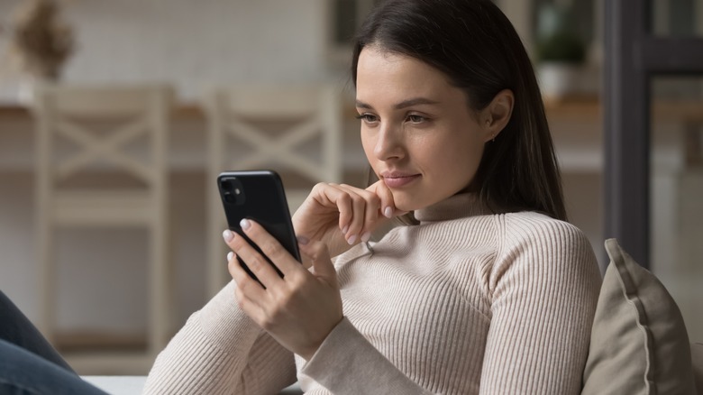 Woman looking down at phone