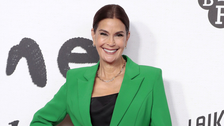 Teri Hatcher smiling while wearing a green blazer