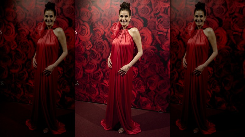 Teri Hatcher in a red dress with a floral embellishment on the neckline
