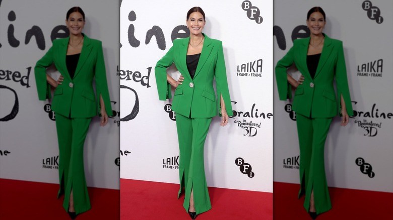 Teri Hatcher in a green suit with flared hems and cuffs