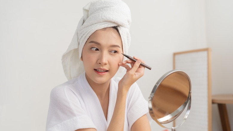 woman about to apply eyeliner