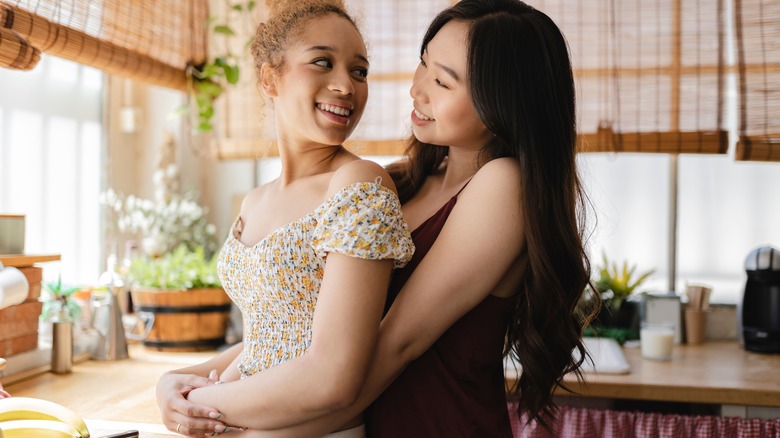 Woman embracing partner from behind