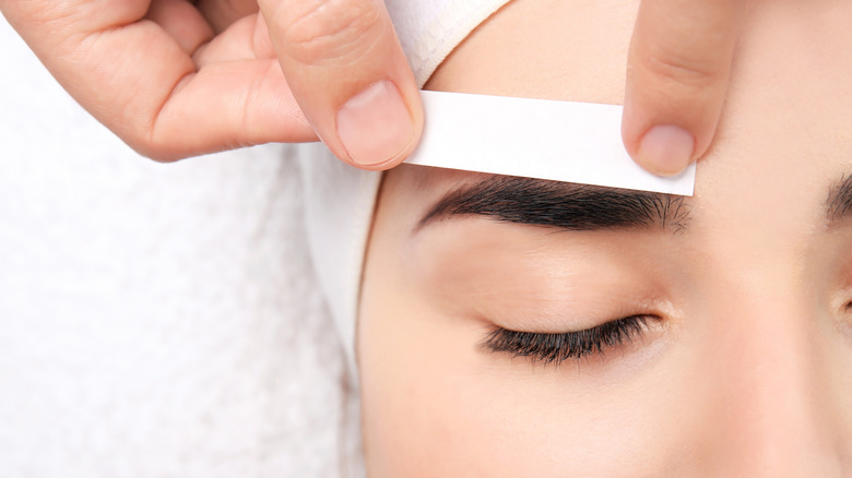 Eyebrow being waxed