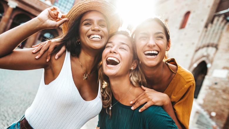 Three women smiling together