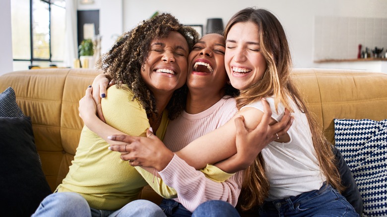 Three friends hugging