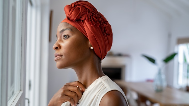 Contemplative woman looking out window
