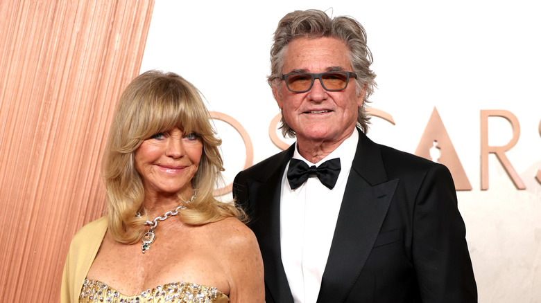 Goldie Hawn and Kurt Russell pose next to each other on the red carpet at the 2025 Academy Awards.
