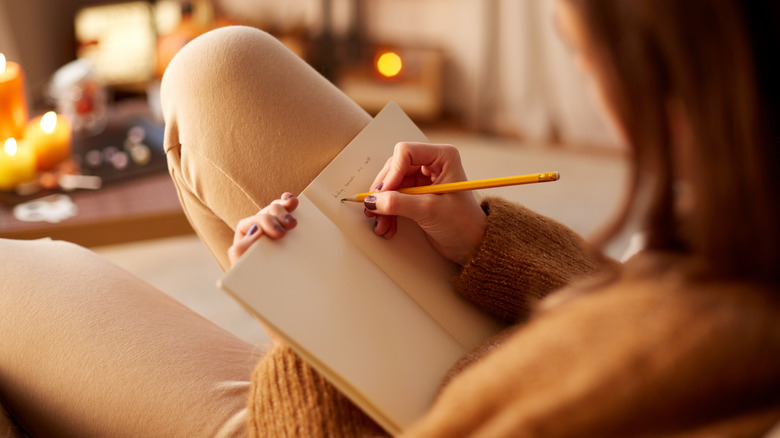 Person writing in journal 