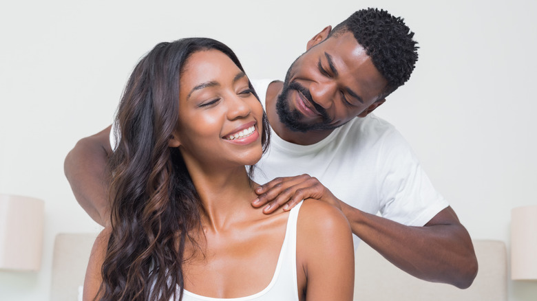 Man giving partner a shoulder rub