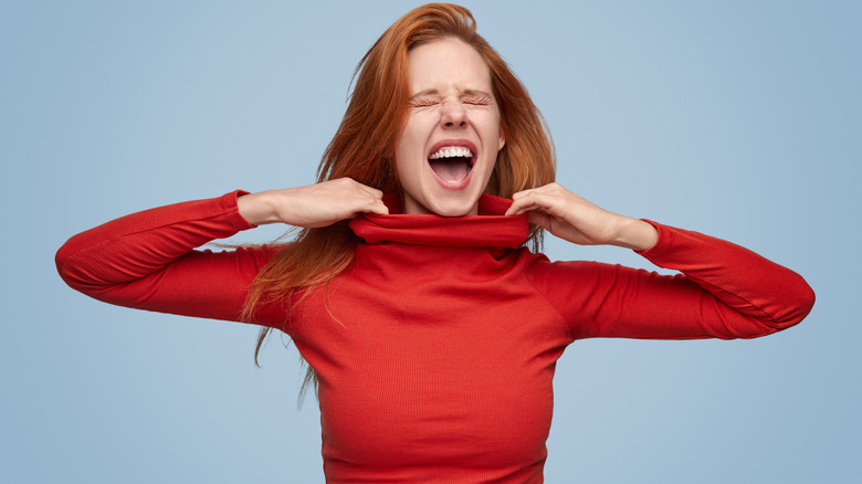 woman wearing tight red sweater