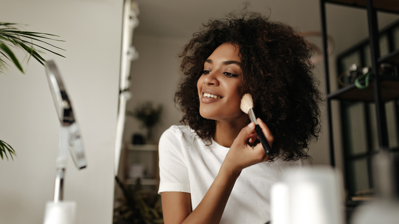 woman applying makeup