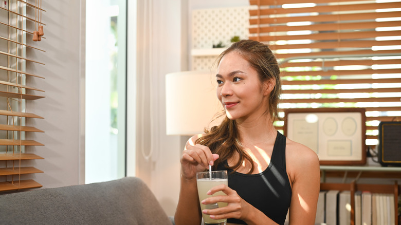 Woman drinking collagen powder