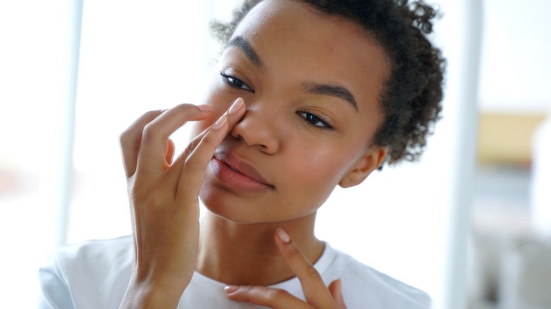 Woman applying under-eye product