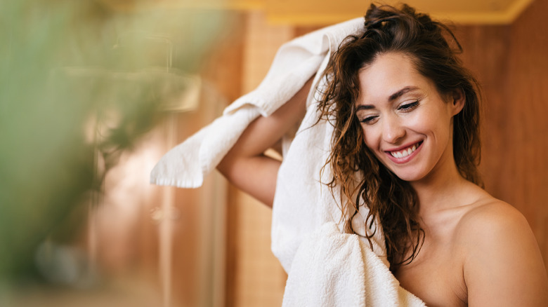 Woman drying hair with towel