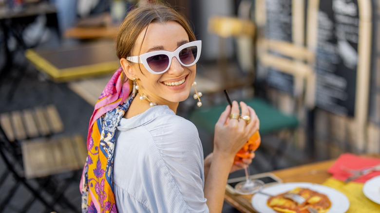 Woman enjoys dining alone outdoors