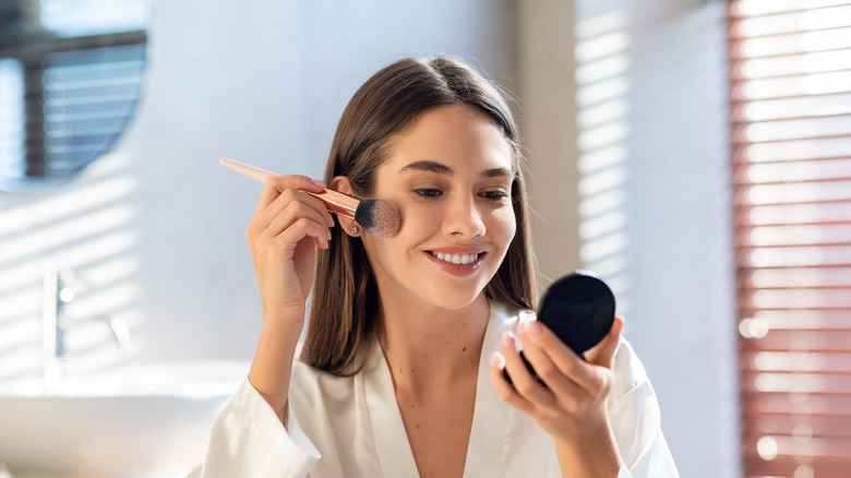 Woman applying makeup