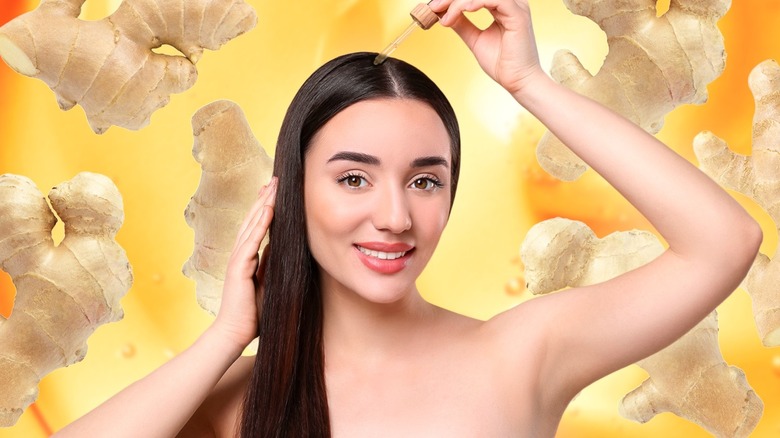 Woman applies ginger oil to scalp 