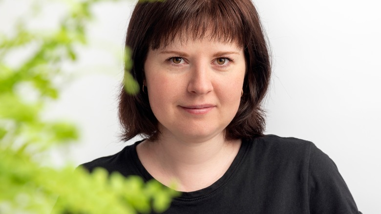 Woman smiling with a plant