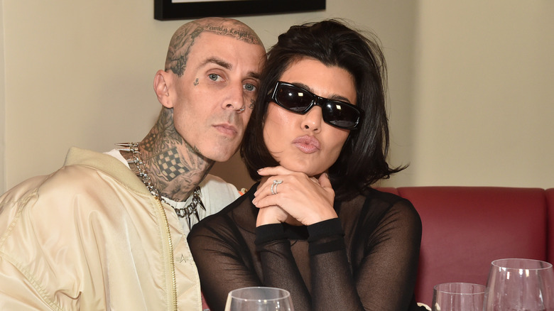 Kourtney Kardashian posing with Travis Barker