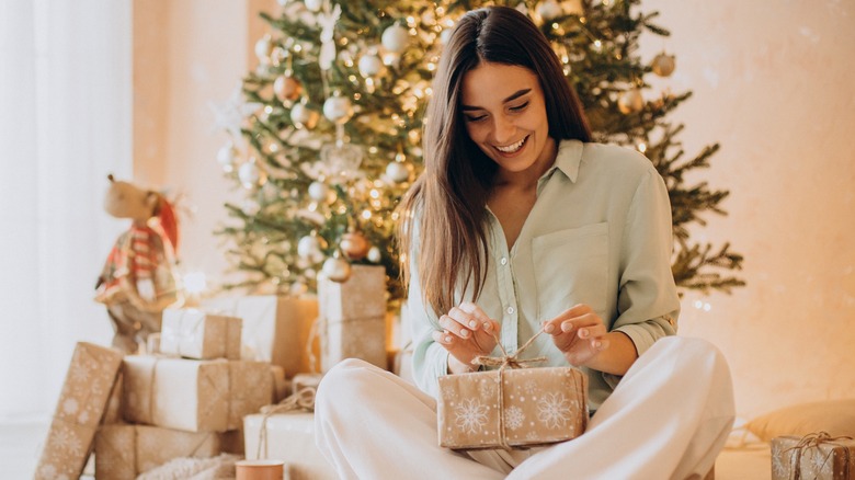 Woman opening a christmas present