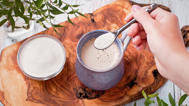 Close up of person stirring collagen powder