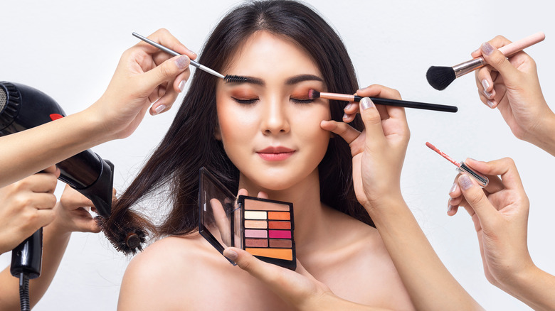 woman getting her makeup done