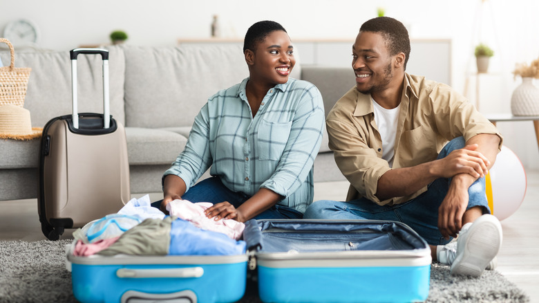 couple packing for a vacation