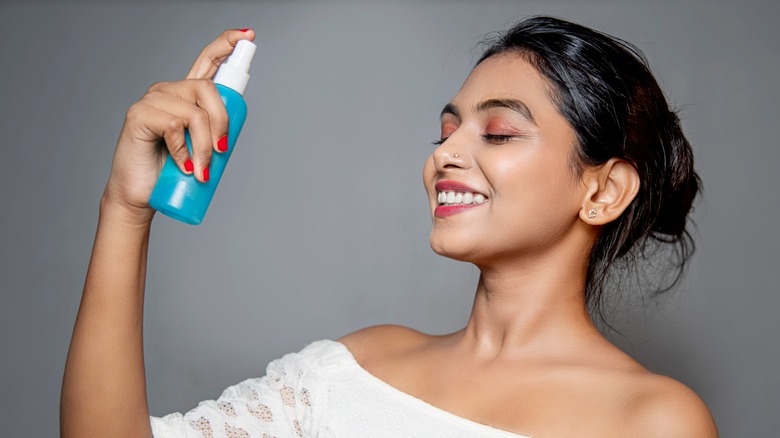 woman using setting spray