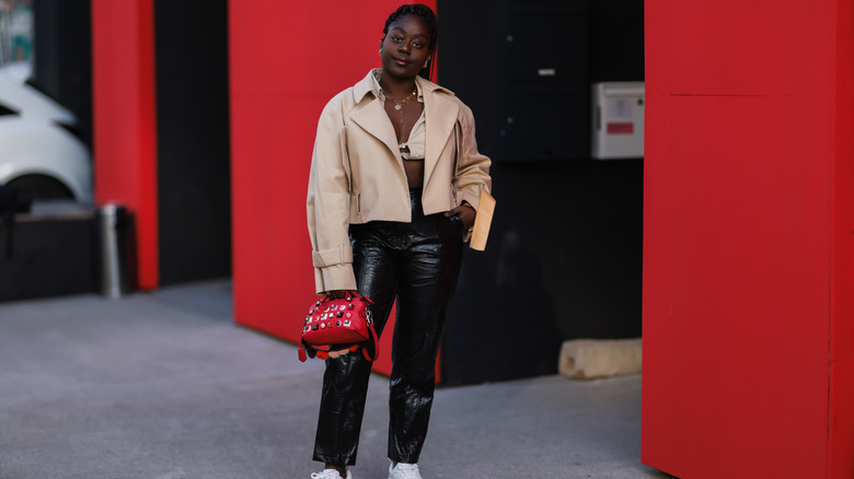 Woman wearing shiny black pants