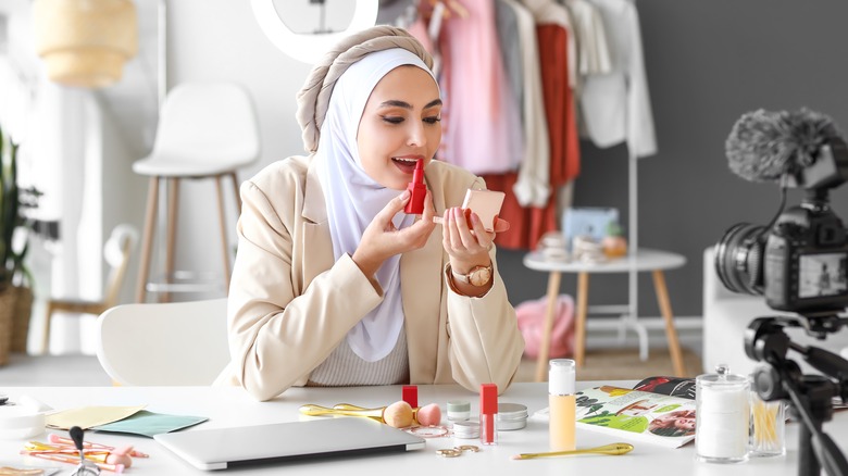 woman applying lipstick