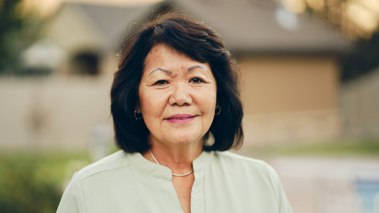 An older woman with a blunt bob and bangs