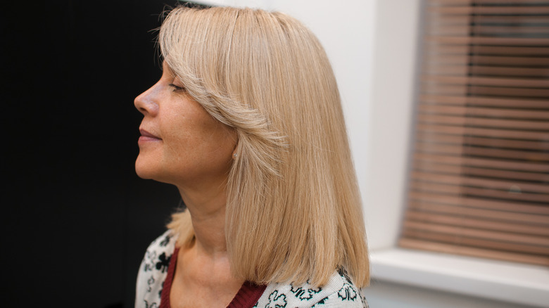 Mature woman with blond lob and curtain bangs