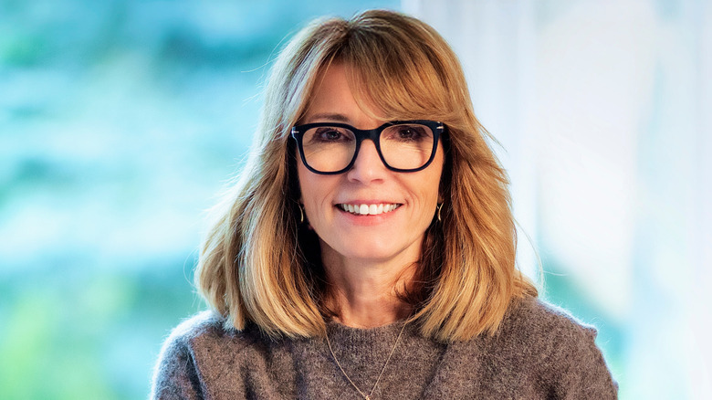 A woman with a layered lob and face-framing pieces