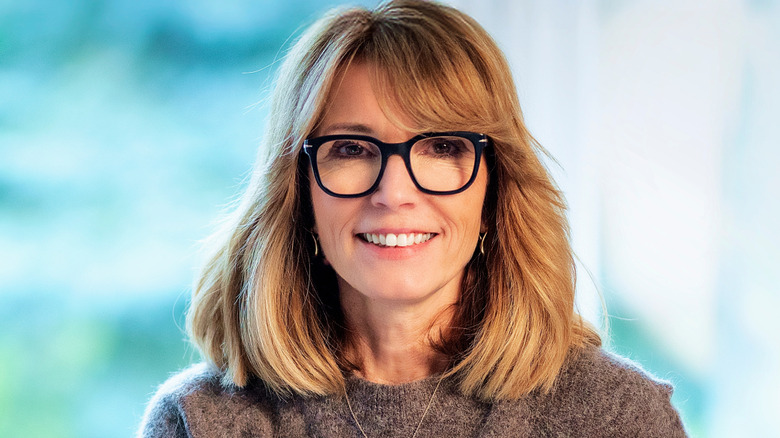 A woman with a layered lob and face-framing pieces