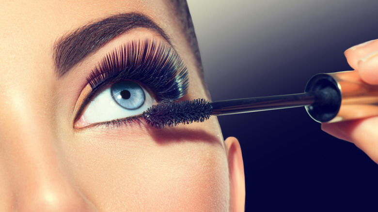 Woman applying mascara