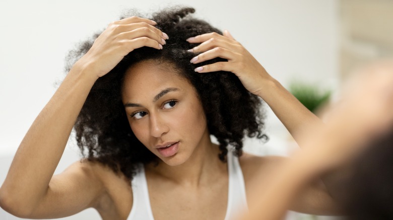 woman looking at scalp 