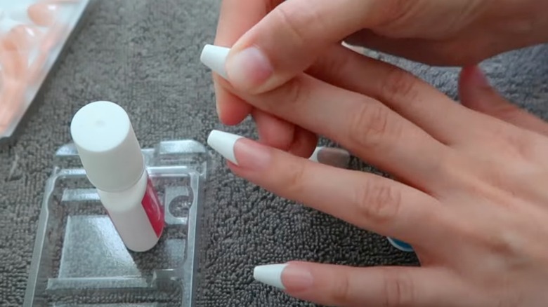 woman applying press-on nails