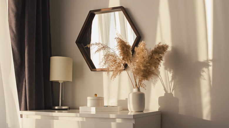 white dresser with hexagon mirror 