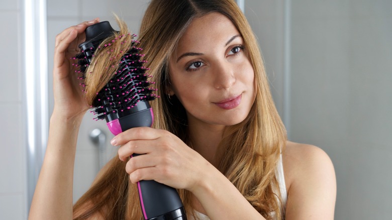 woman using round brush