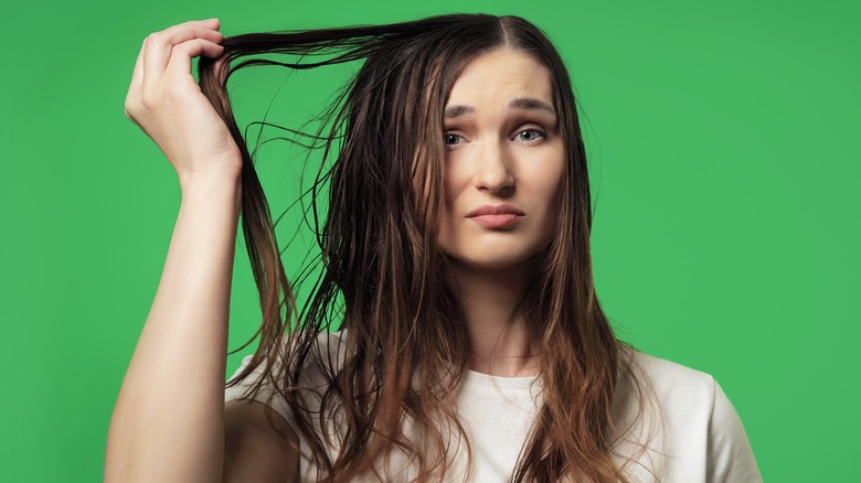 A woman with greasy hair