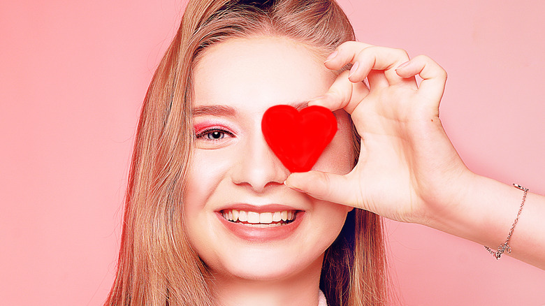 Woman in pink holding heart for Valentine's Day