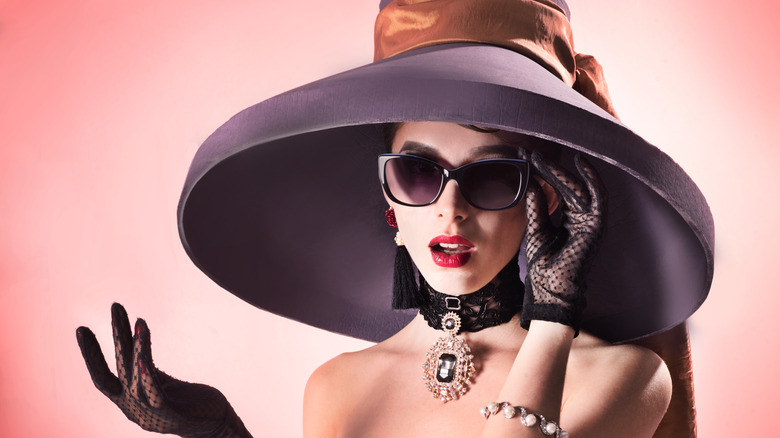 Woman poses in Audrey Hepburn inspired sunglasses