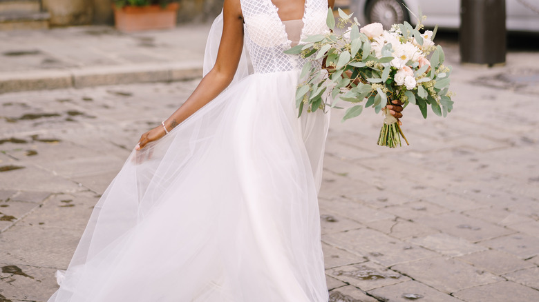 Bride holding white floral bouquet