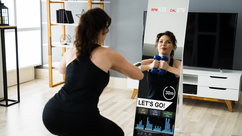 Woman using a fitness mirror 