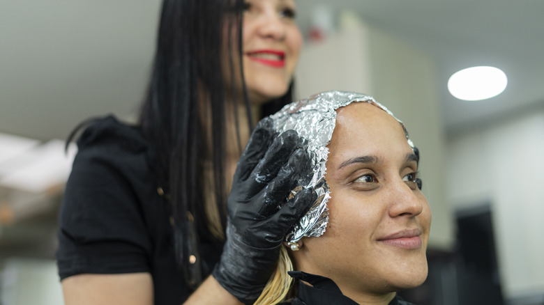 woman getting hair bleached 