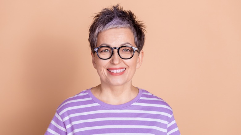 A woman wearing a purple striped shirt.