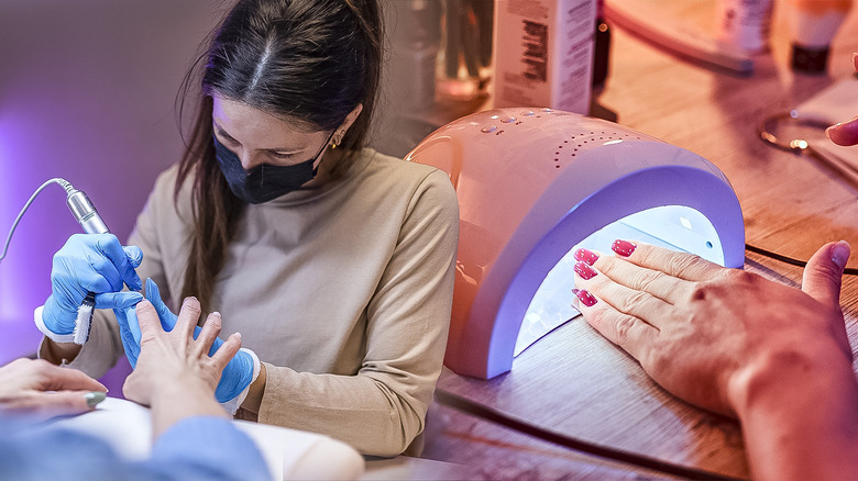 Women getting manicures at salon