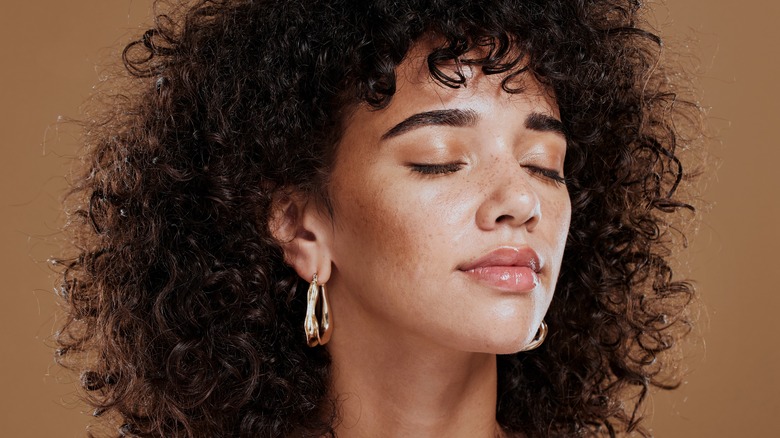 Close-up of woman with dewy, natural makeup