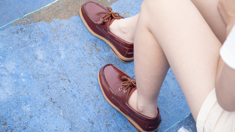 Woman wearing maroon leather boat shoes