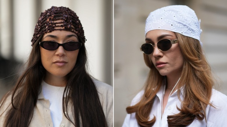 A woman wearing a crocheted beanie and one wearing a head scarf